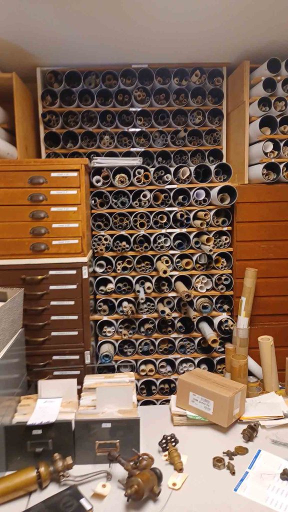 a wall of rolled paper plans in the NWPRRHS library